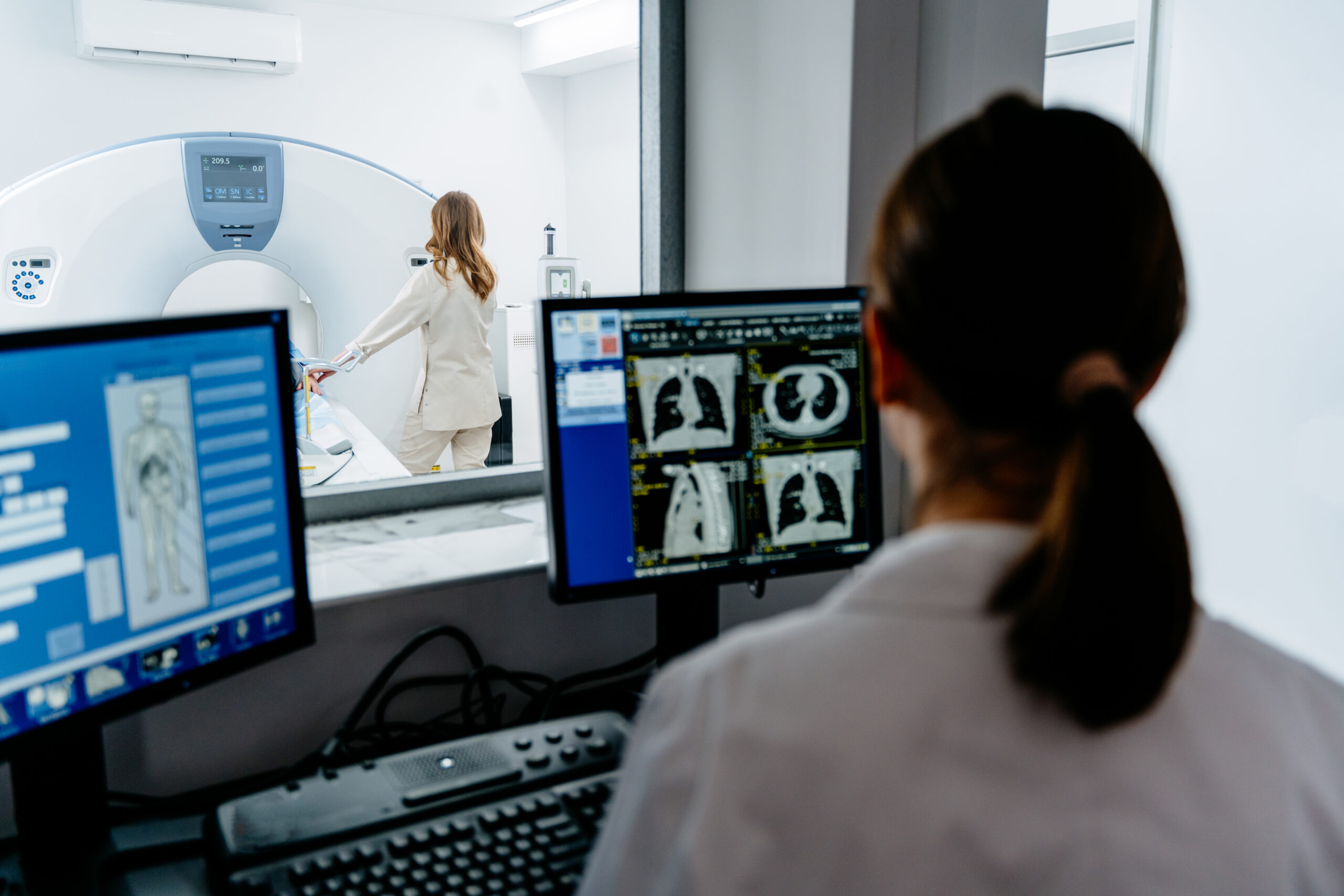 Medical professional analyzing scans during tomography procedure
