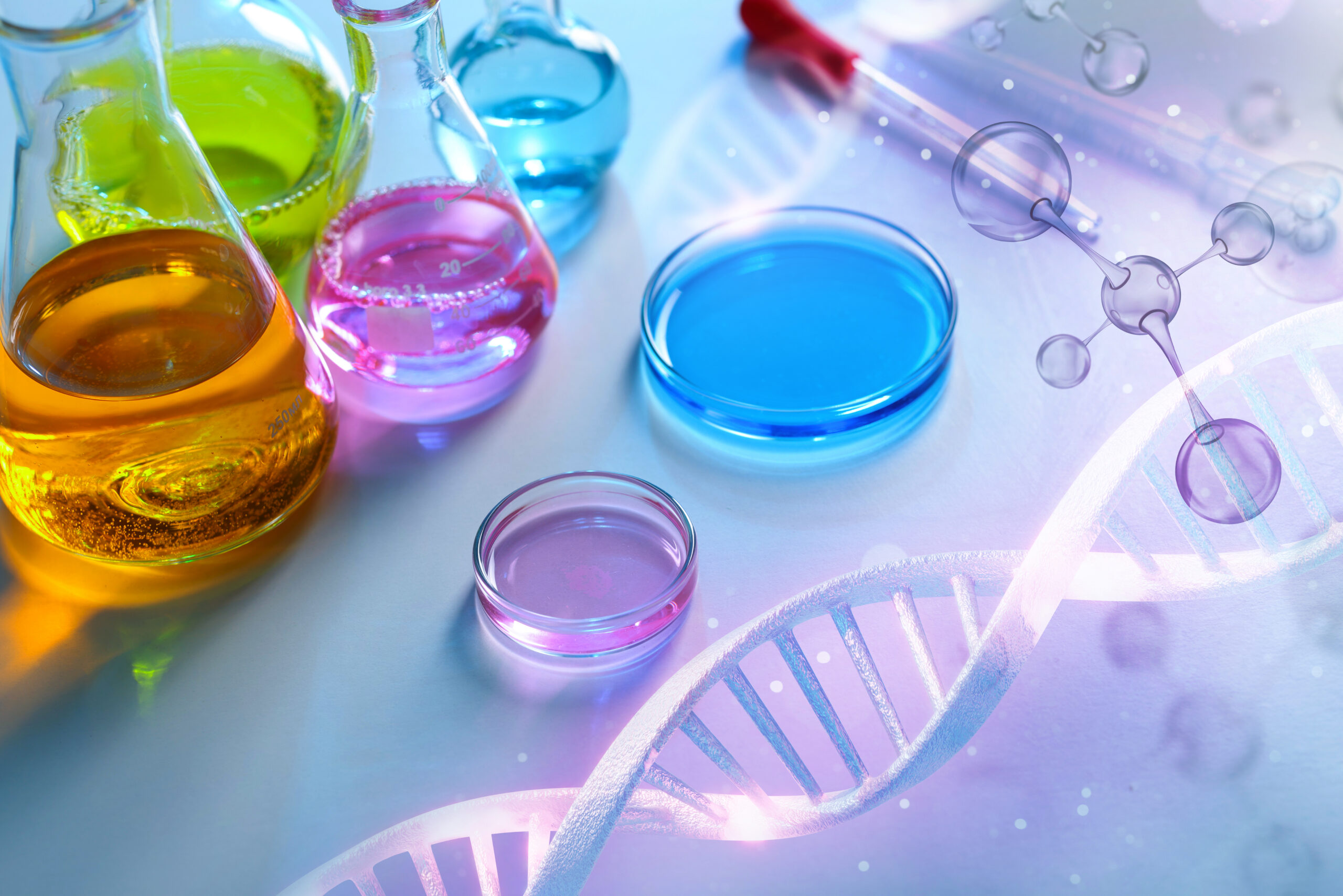 Laboratory glassware with different samples on light table, closeup