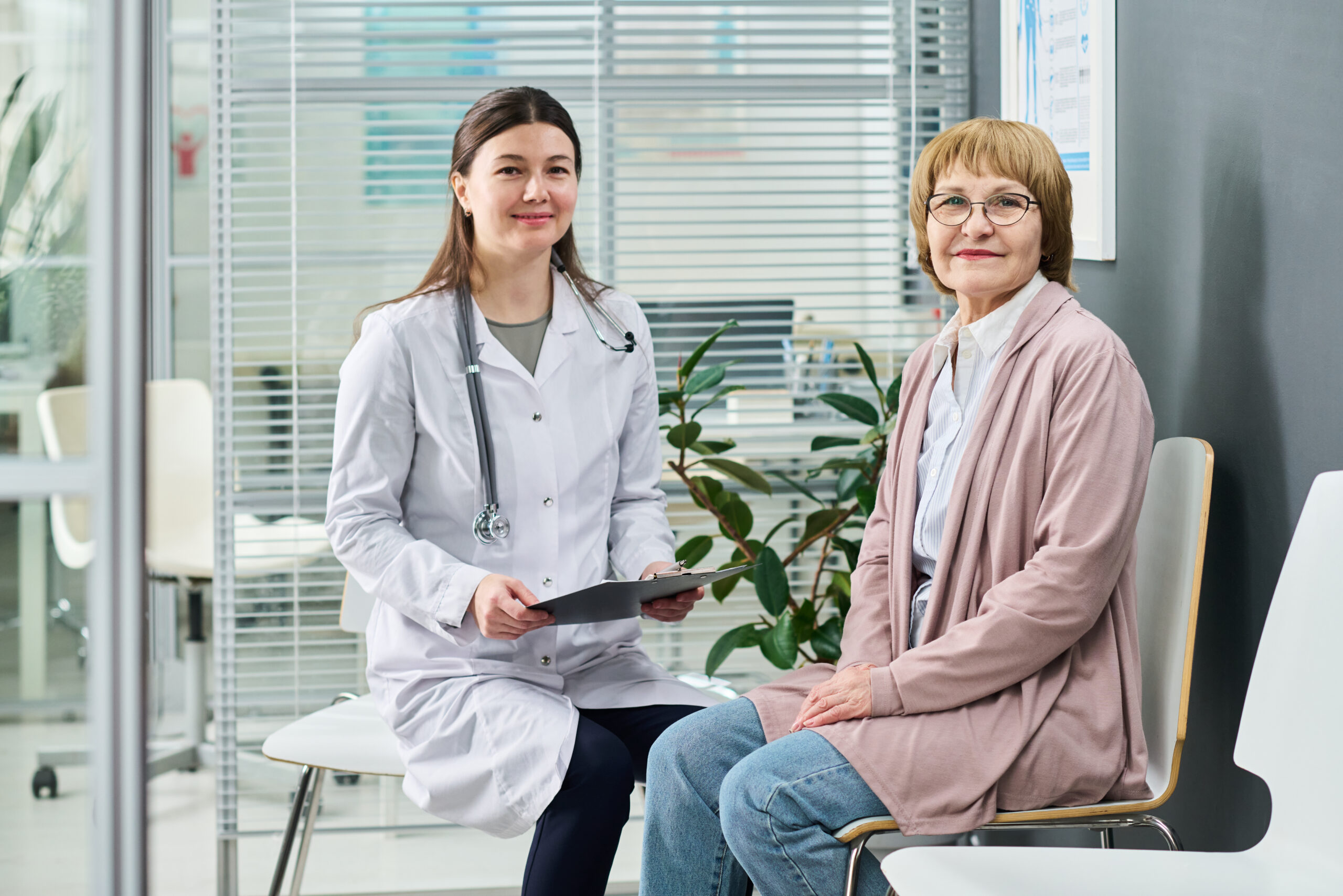Female Doctor Consulting Senior Woman in Medical Office