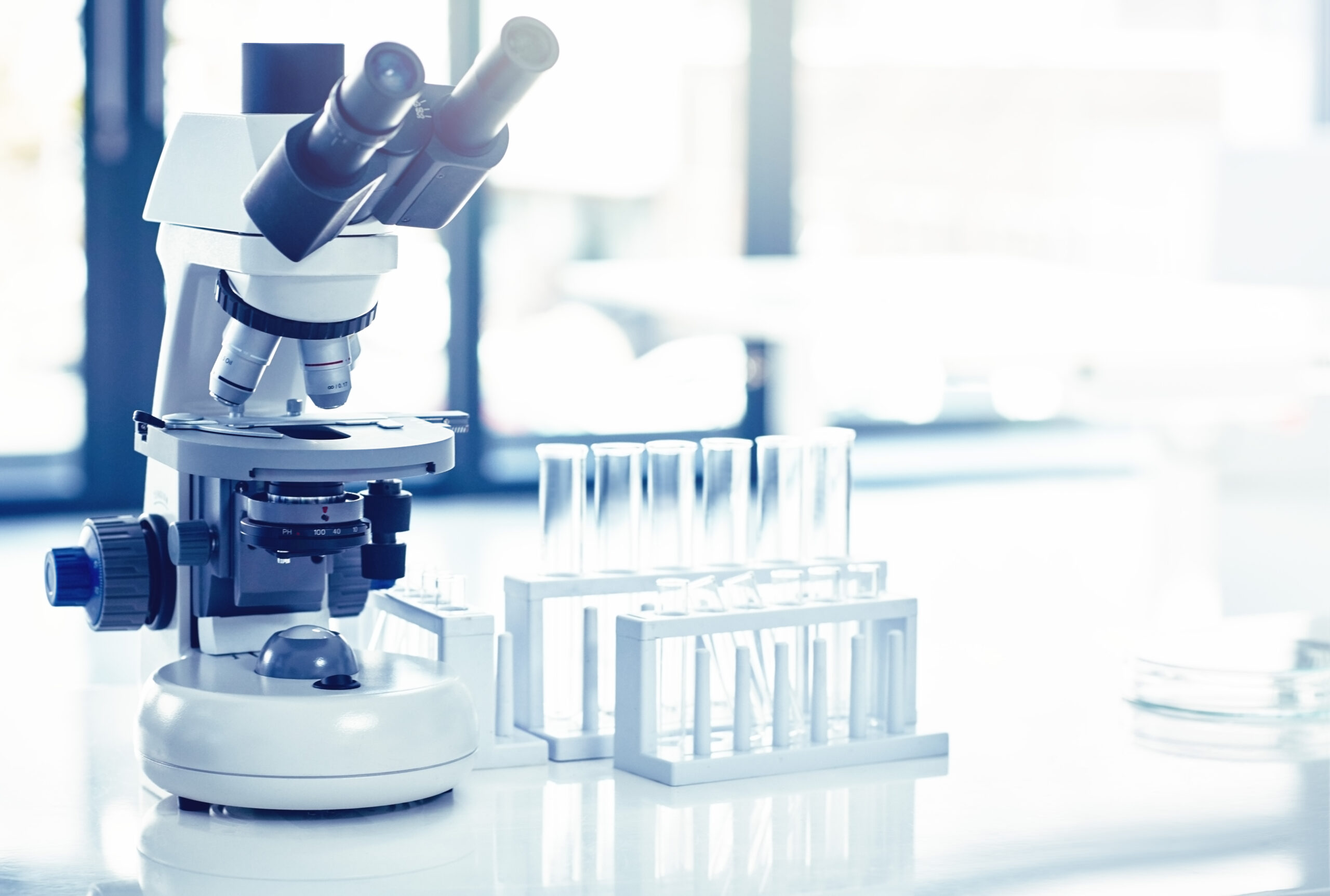 laboratory-microscope-and-test-tubes-on-white-tabl-2026-03-25-03-26-44-utc