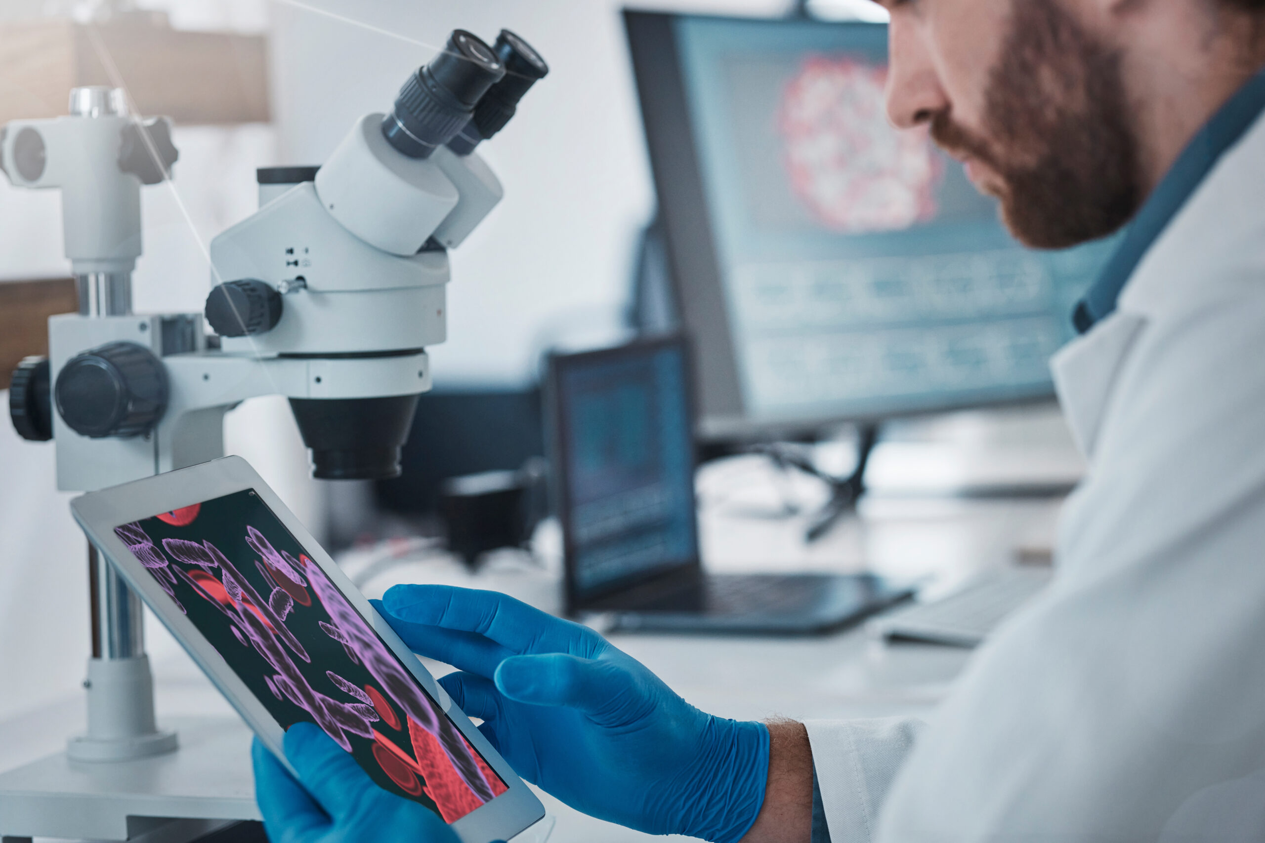 scientist-using-tablet-with-microscope-at-workplac-2026-01-09-09-35-17-utc